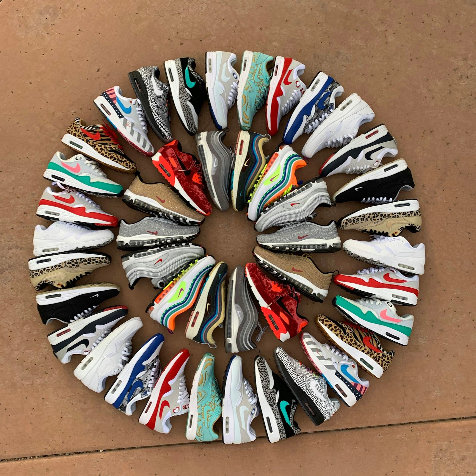 Circle of Nike Air Max sneakers laid out on the floor